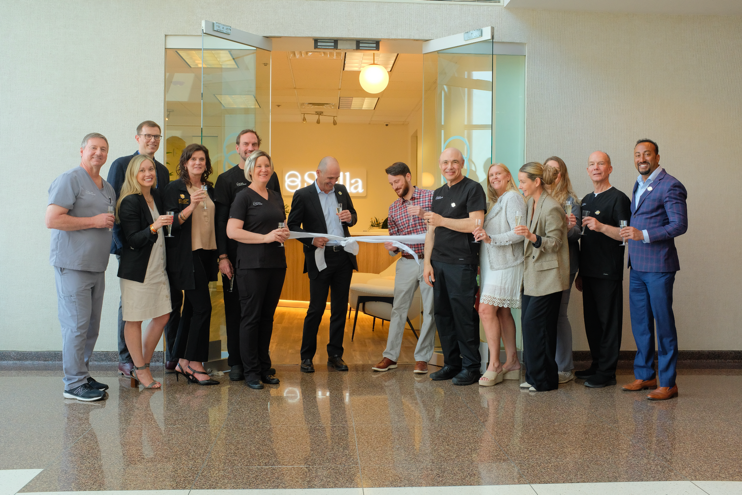 Stella's leadership gather for a ribbon cutting ceremony
